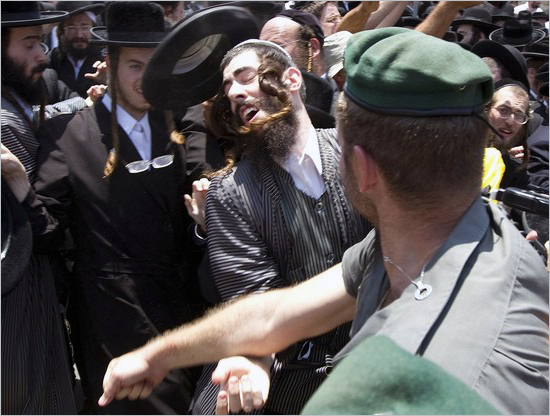 Anti-Zionist, Ultra-Orthodox Jewish men clash with Israeli police as they protest against the removal of ancient tombs in Jaffa, just south of Tel Aviv, on June 16, 2010 where construction is due to take place at the site where religious men say Jewish graves are located.