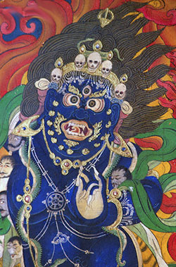 Located near the entrance to the monastery is a large painting of Hevajra. Hevajra is a supreme yoga tantra deity. He is dark blue in color with eight faces, two (or sixteen) arms and four legs. He wears bone ornaments, a tiara of five skulls and a necklace of fifty-one severed heads. LY004859.jpg
