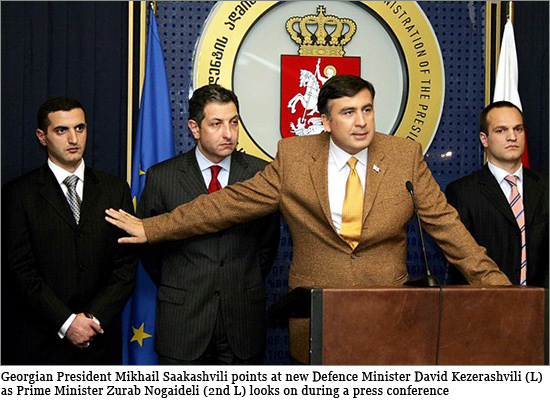 Georgian President Mikhail Saakashvili (2nd R) points at new Defence Minister David Kezerashvili (L) as Prime Minister Zurab Nogaideli (2nd L) looks on during a press conference at the presidential office in Tbilisi Temur-Yakobashvili.jpg