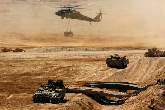 An Israeli helicopter is seen flying above armored vehicles during an army exercise at the Shizafon Army Base in southern Israel barakhenaten.jpg