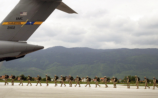 Bosnian soldiers walk toward a U.S. military plane at Sarajevo's airport June 1, 2005 as they leave for their mission in Iraq. Serbs, Croats and Muslims who completed training this month for the first army unit bringing together Bosnia's warring fractions of 10 years ago, left for Iraq to join U.S.-led coalition forces. cro.jpg