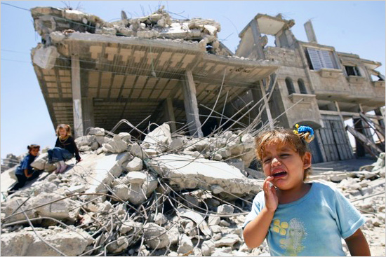 Palestinian children play in front of their ruined houses, hit during Israel's 22-day offensive over Gaza, on July 02 2009 in Rafah, southern Gaza Strip. gaza_jul.jpg