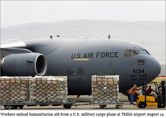 Workers unload humanitarian aid from a U.S. military cargo plane at Tbilisi airport August 14, 2008. humanitarian-aid.jpg