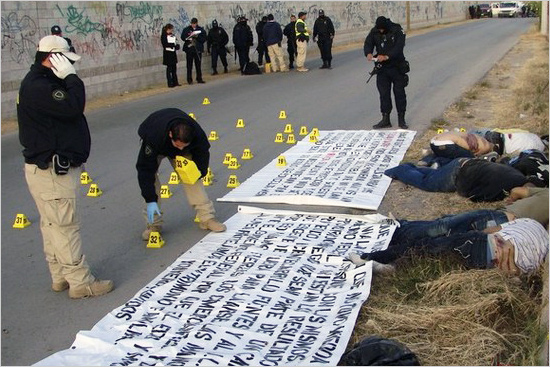 Police investigators work at a crime scene where seven bodies were found gunned down in the border city of Ciudad Juarez, northern Mexico, November 25, 2008. The bodies of seven men with signs of torture and bullet wounds were found along side three banners threatening rival gangs, according to local media. More than 4,300 people have been killed in drug violence this year as cartels from Sinaloa state try to dominate the Mexican drug trade, fighting rivals and the security forces. juarez_550.jpg