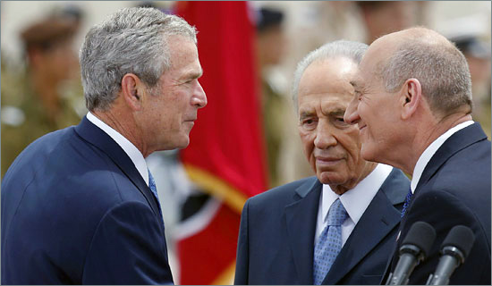 President George W. Bush, left, meeting Prime Minister Ehud Olmert of Israel, as President Shimon Peres looks on at Ben Gurion airport near Tel Aviv on Wednesday. (Kevin Frayer/The Associated Press) mideast-bus.jpg