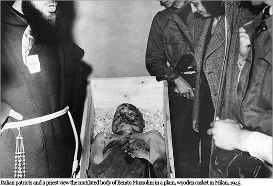 Italian patriots and a priest view the mutilated body of Benito Mussolini in a plain, wooden casket in Milan, 1945. morte_mussolini1_550.jpg