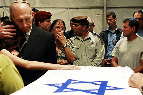 Israeli Prime Minister Ehud Olmert consoles Karnit Goldwasser while she rests her hand on the coffin of her husband Ehud Goldvasser at the Shraga army base on July 16, 2008 nuovo-Hitler.jpg
