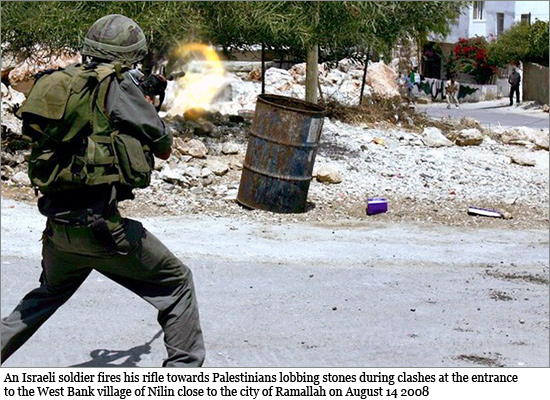 An Israeli soldier fires his rifle towards Palestinians lobbing stones during clashes at the entrance to the West Bank village of Nilin close to the city of Ramallah on August 14 2008 pal_stones.jpg