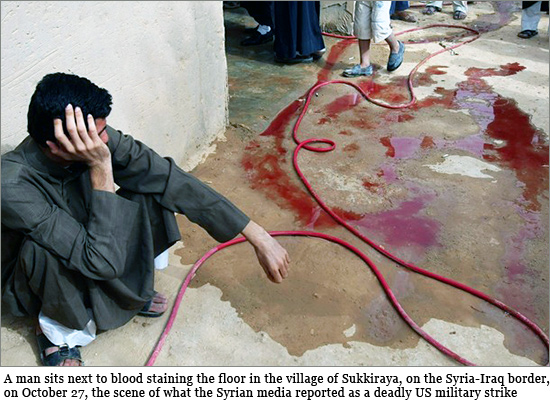 A Syrian man sits next to blood staining the floor in the village of Sukkiraya, on the Syria-Iraq border, on October 27, 2008, the scene of what the Syrian media reported as a deadly US military strike. Iraq said today that a deadly raid on Syria killing eight was targeting an area used by insurgents plotting attacks on its soil, as Damascus protested about what it branded a cold-blooded war crime by US forces. syria_raid_550.jpg