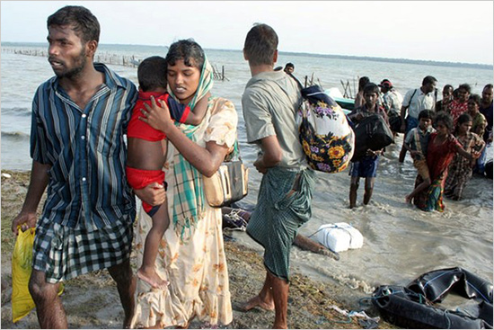 This photograph released by the Sri Lankan military May 15, 2009 shows what the army say are civilians wading and using inflatable tubes across a lagoon to escape the island's war zone, where the military has surrounded Tamil Tiger rebels for the final battle in a quarter-century conflict. tamil.jpg
