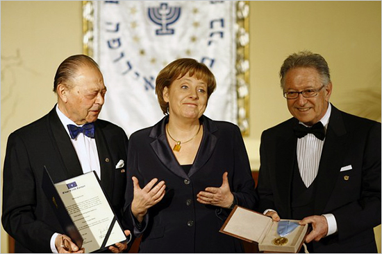 German Chancellor Angela Merkel (C) poses with Reinhold Simon (R), President of the Jewish Independent Order of B'nai B'rith, and the order's honorary president Joseph H. Domberger (L) after she was awarded the B'nai B'rith Europe Award of Merit on terrorism_germany.jpg