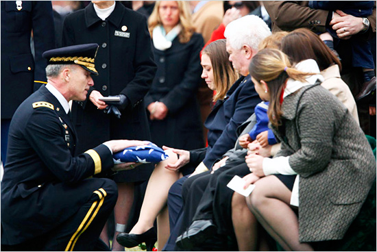Army Lt. Gen. David Huntoon, Jr., kneels as he presents an American flag to Nicole Bunting, the widow of Army Capt. Brian M. Bunting, 29, of Potomac, Md., Monday, March 16, 2009, at Arlington National Cemetery in Arlington, Va. Bunting, a member of the Individual Ready Reserve, assigned to the 27th Infantry Brigade Combat Team, Syracuse, N.Y., died Feb. 24 in Kandahar, Afghanistan, of wounds suffered when an improvised explosive device detonated near his vehicle. (AP Photo/Haraz N. Ghanbari) # vietnam_again.jpg